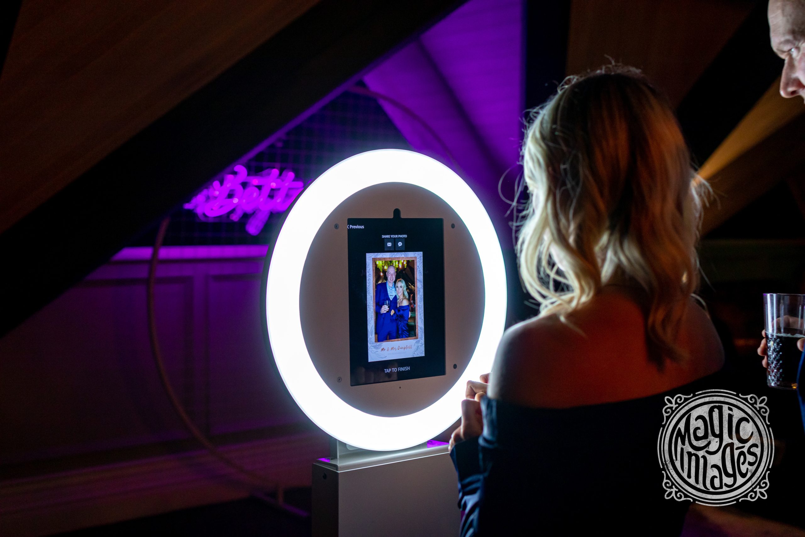A guest taking a photo using the photo booth